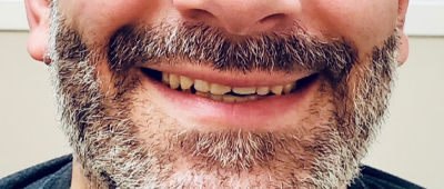 A man with beard smiling